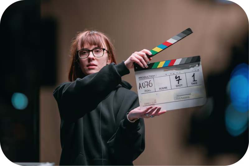 Woman Holding/Directing Movie Scence