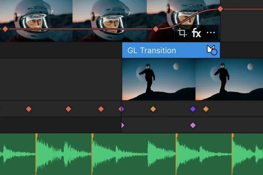 Video editing timeline showing clips of a person in a helmet and a silhouette of a person walking on a hill with waveform audio tracks below.