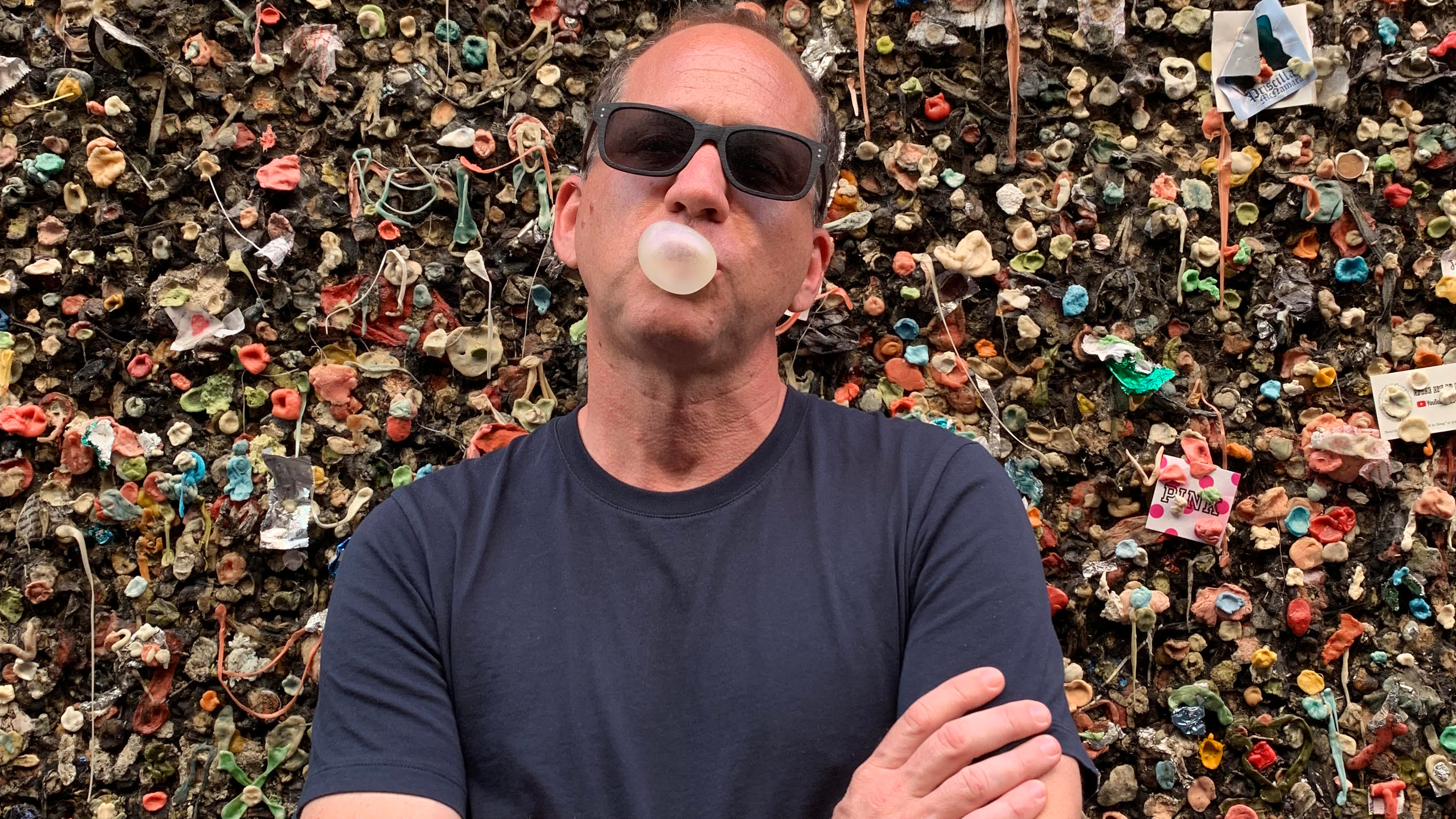 Brian Drewes in front of a wall of gum