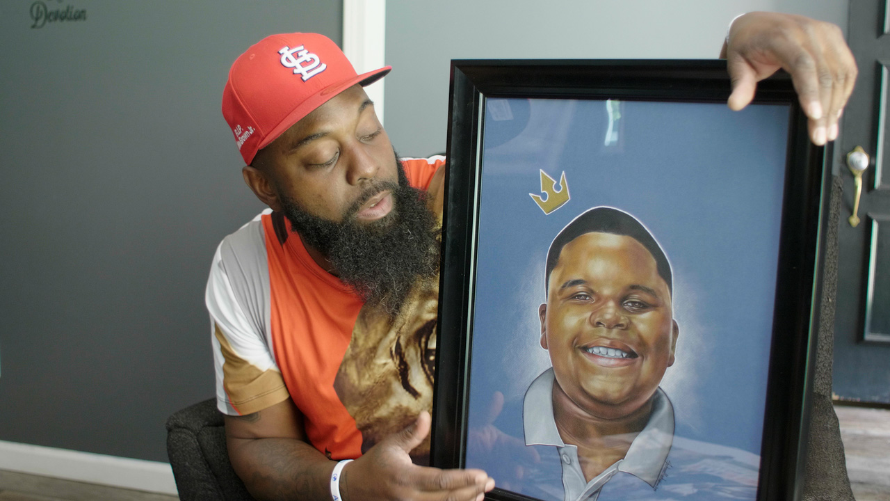 Ferguson Rises photo with painting of Michael Brown, Junior