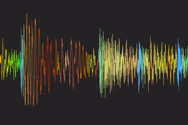 Colorful audio waveform visualization on a black background showing varying frequencies and amplitudes.