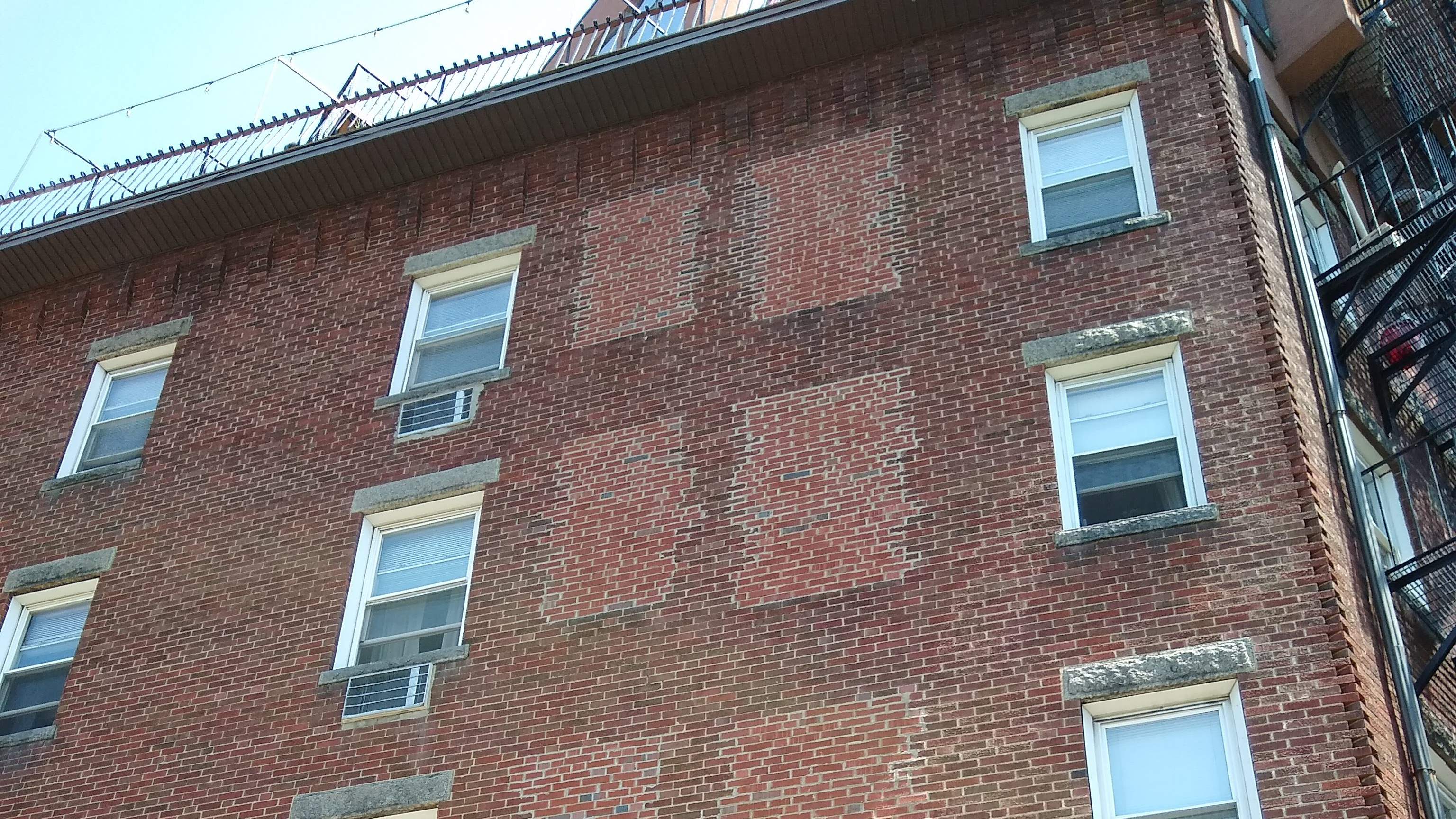 brick building facade with window bricked over